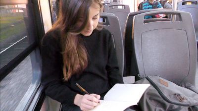 Céline working hard on the train to visit a project